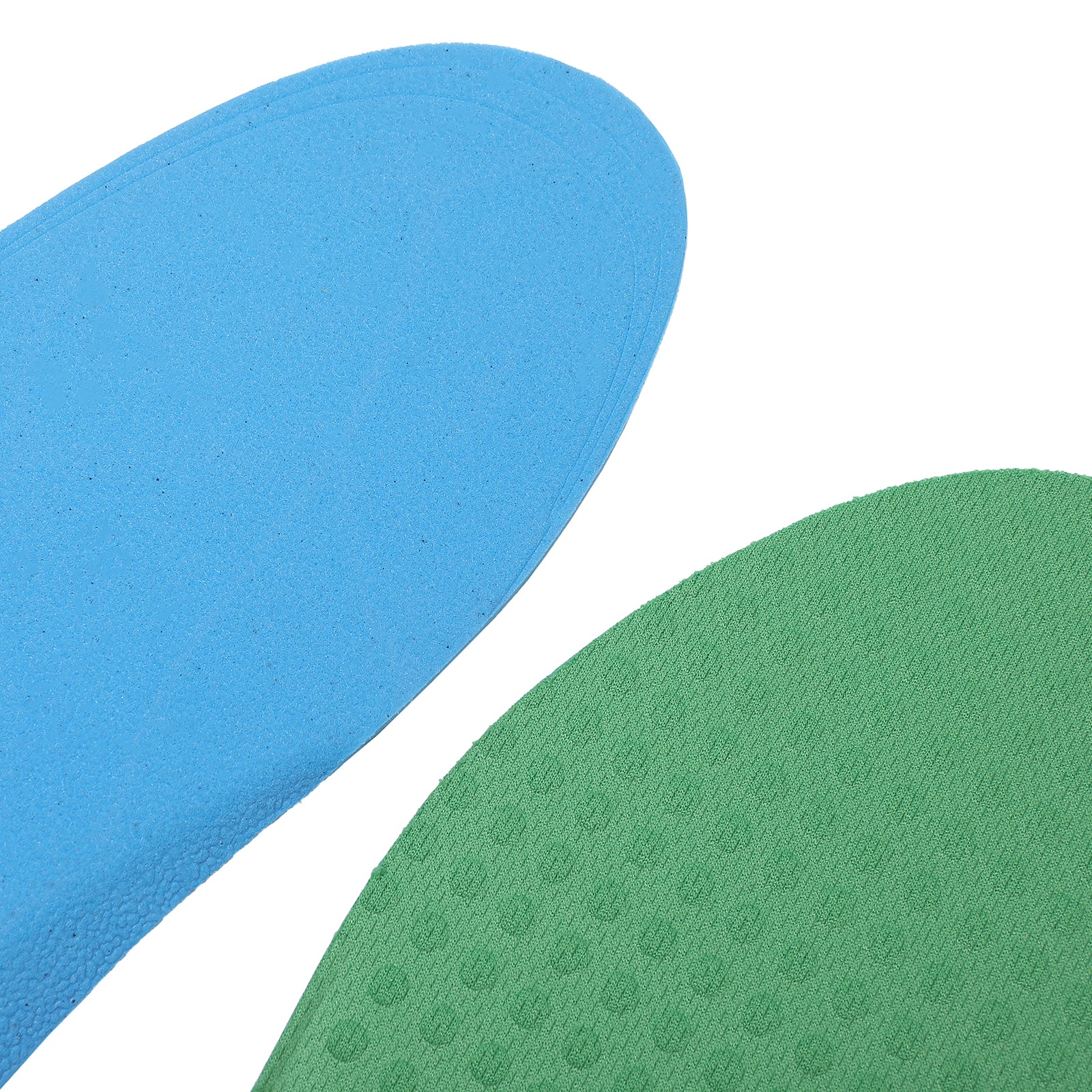 Close-up of soft, flexible insoles in blue and green, showing their cushioning and surface texture.