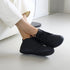 Black George barefoot shoes worn by a person in office background 