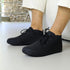 Black George barefoot shoes worn by a person in office background 