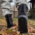 back view of high winter barefoot boots with sole detail in a mountain house with autumn leaves on the grass
