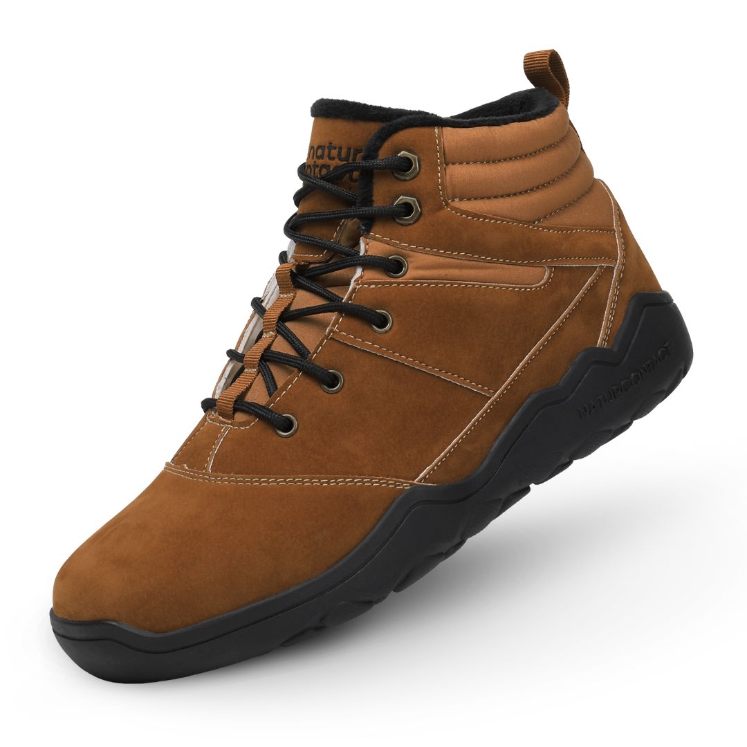 Gold winter barefoot shoe with black laces on a white background, featuring 'Naturcontact' branding. angled side view.