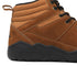 Gold winter barefoot shoe with black laces on a white background, close-up side view.
