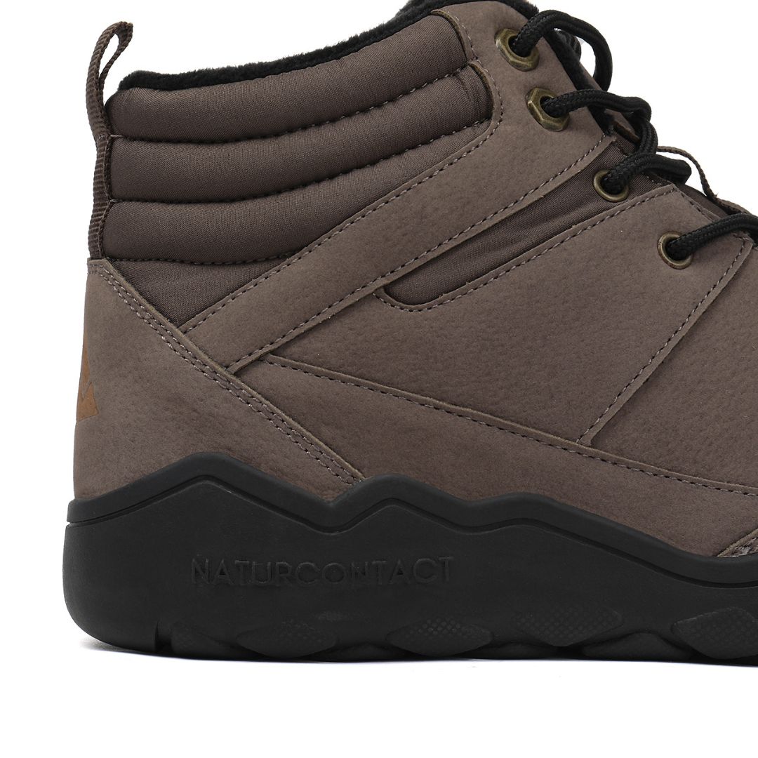 Dark brown winter barefoot shoe with black laces on a white background, close-up side view.
