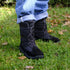 Person wearing black winter barefoot boots on grass, showcasing the side and front view of the Naturcontact Lapland model