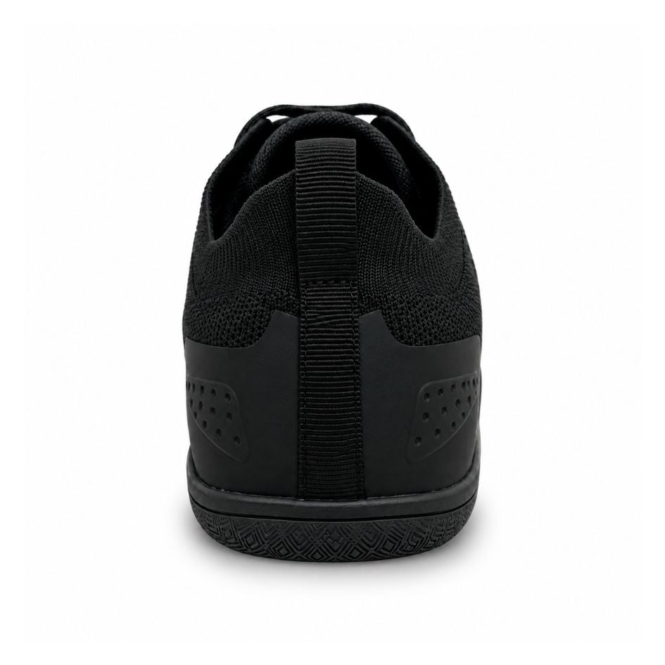 Rear view of all-black Aramid Contact 2.0 barefoot trainers showing the heel pull loop, stitched heel panel and black outsole.