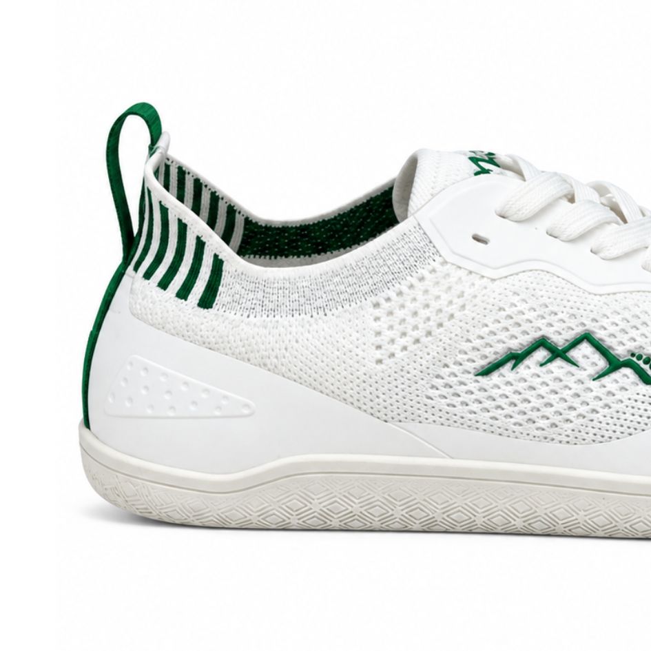 Close-up of the white Aramid Contact 2.0 heel area showing the green pull tab, green-striped lining and textured white mesh panels.
