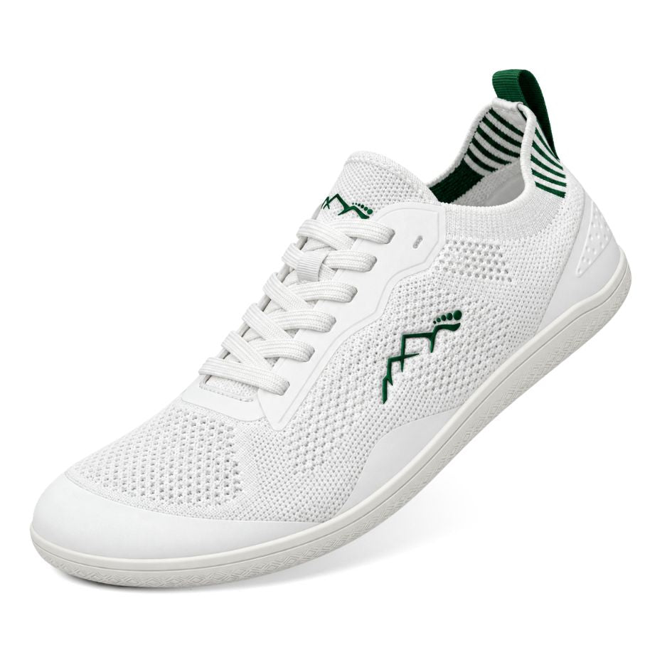 Three-quarter view of white Naturcontact Aramid Contact 2.0 barefoot trainers with green accents, breathable mesh upper and flexible white sole.