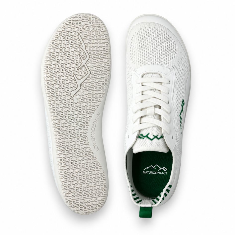 Top and outsole views of white and green Aramid Contact 2.0 barefoot shoes showing white laces, green interior accents and textured white tread.