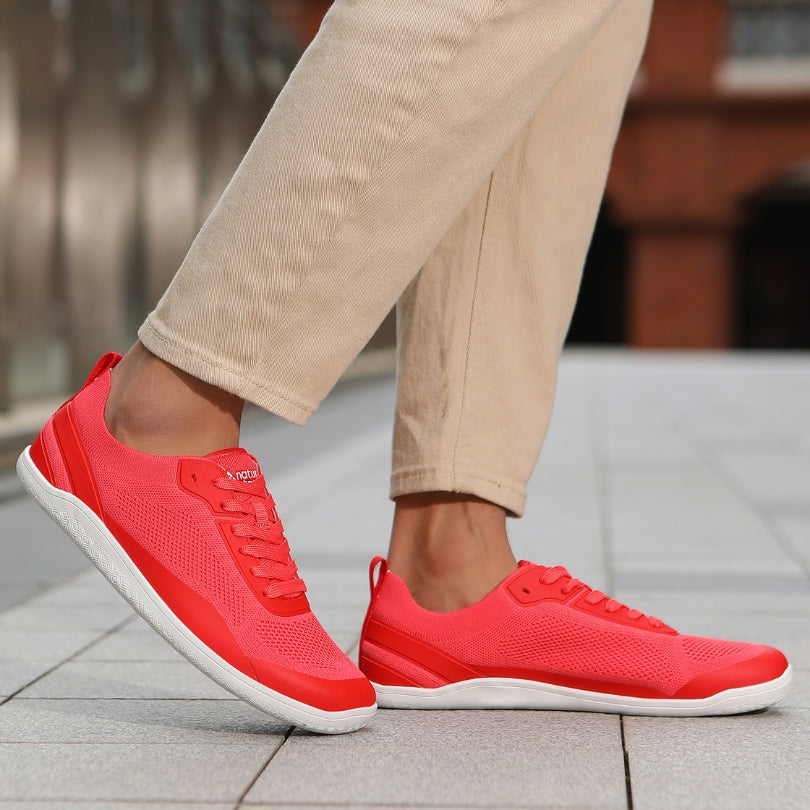 Naturcontact Aramid Contact 3.0 barefoot shoes in coral red worn for everyday walking with flexible minimalist sole