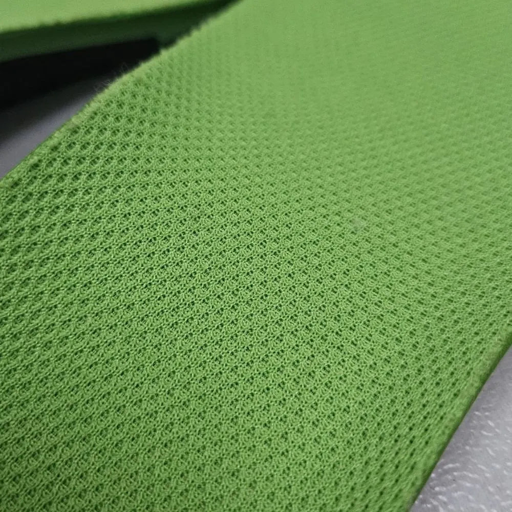 Close-up of breathable mesh fabric on barefoot shoe insoles with soft, textured surface.
