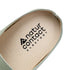 Close-up of a barefoot suede clog insole with 'natur contact barefoot' branding on a white background