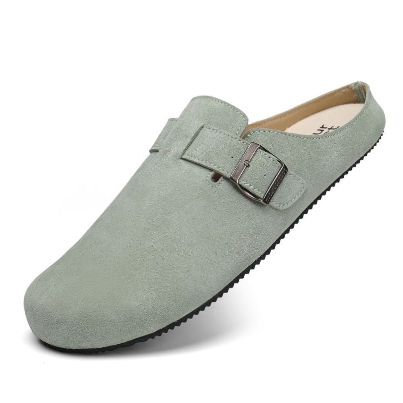 Green barefoot suede clog with a buckle on a white background