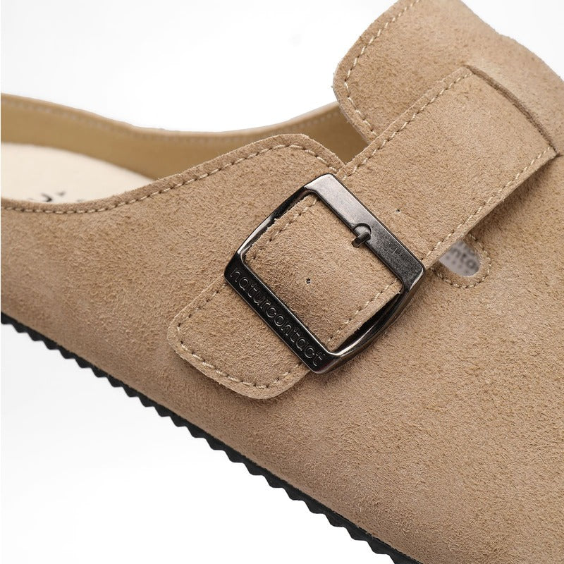 Close-up of a barefoot suede clog with a buckle with logo naturcontact on a white background
