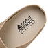 Close-up of a sand beige barefoot suede clog shoe sole with 'natur contact' branding on a white background