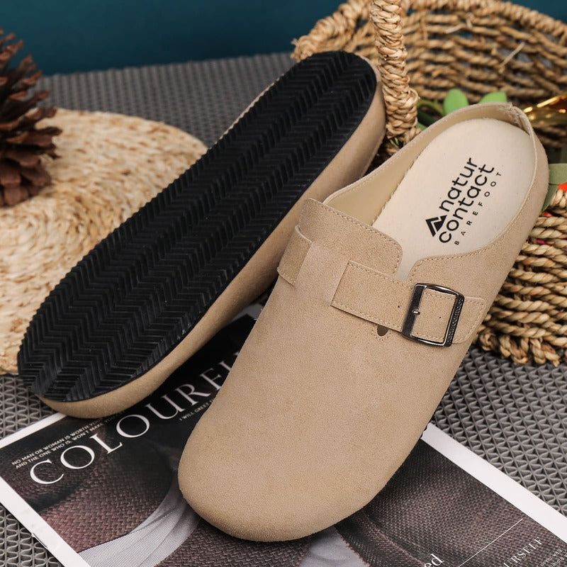 Beige sand barefoot suede clogs with a buckle on a textured surface with 'natur contact' branding.