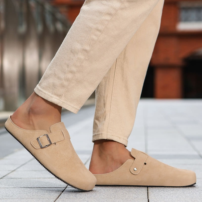 Beige sand barefoot suede clog worn with beige pants on a blurred background