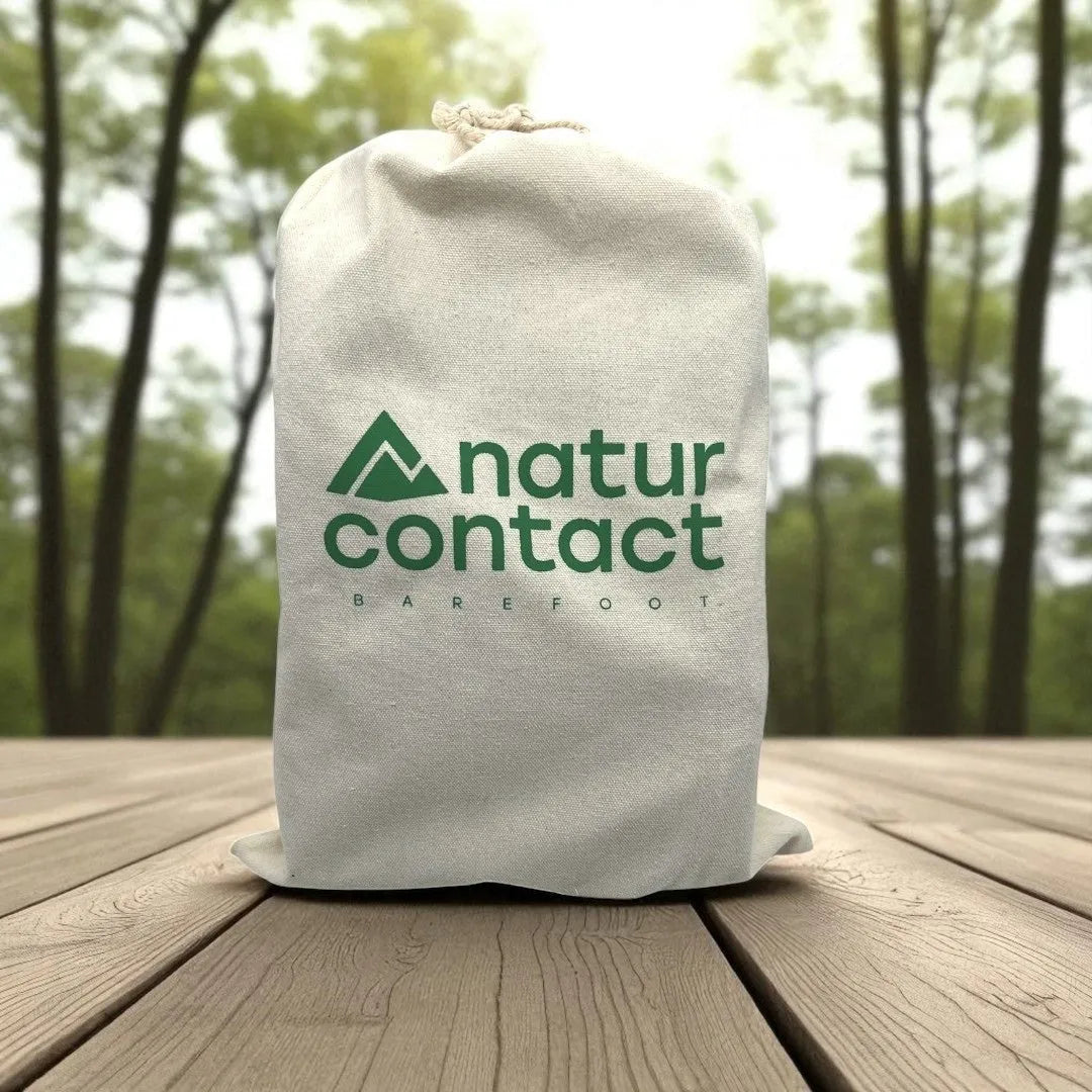 Naturcontact barefoot cotton drawstring bag with logo, displayed outdoors on a wooden surface