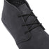 A close-up shot of a black suede ankle boot with black laces, showing the side profile and embossed brand logo on the tongue against a white background.