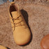 Top view of Naturcontact George Smart barefoot shoes in tan vegan leather worn outdoors on stone surface