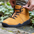 Naturcontact Intemperia winter barefoot boots in Gold suede, worn outdoors on natural terrain, featuring zero drop sole, wide toe box and flexible minimalist design for winter use.