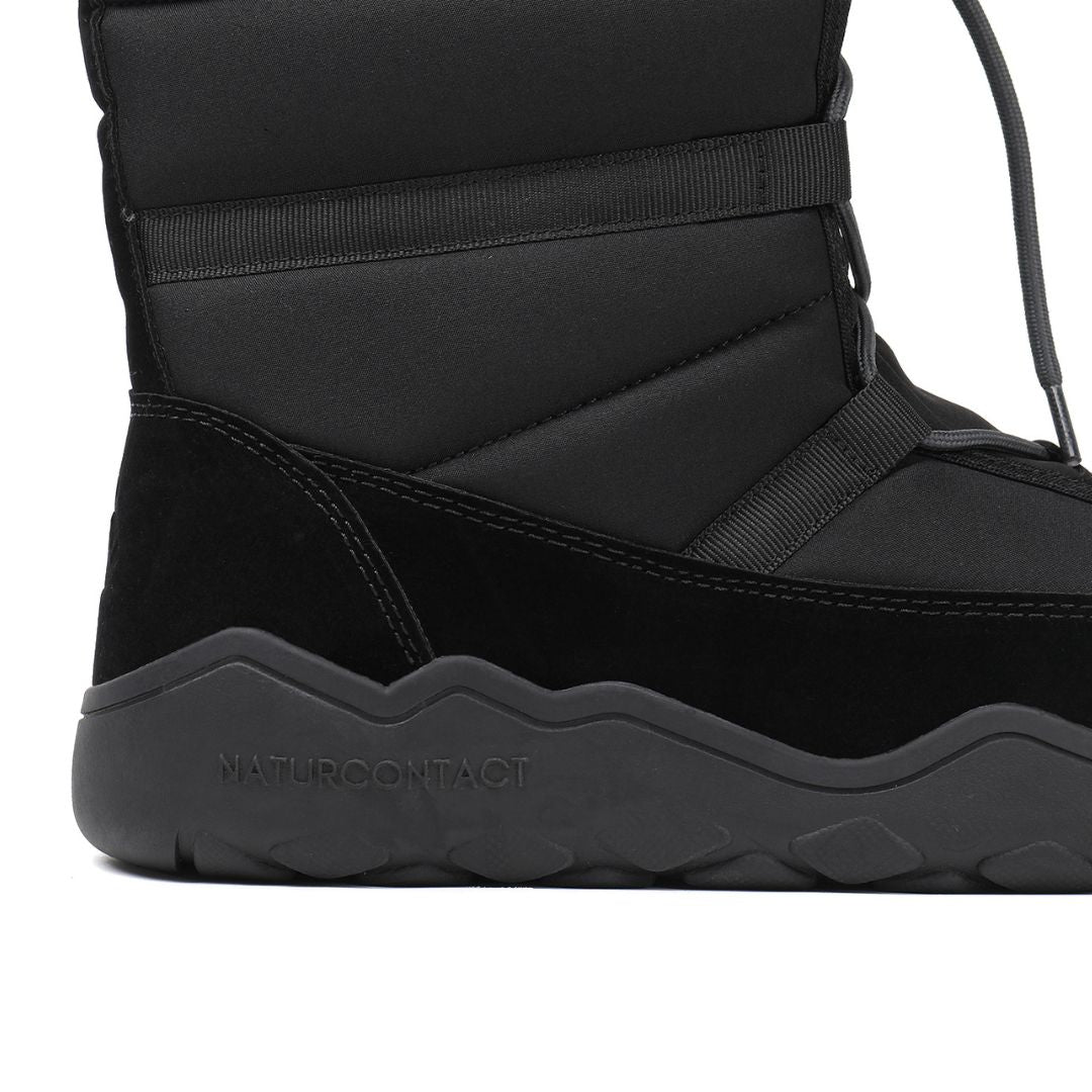 Close-up of black Naturcontact Lapland high-top winter barefoot boots showing flexible high-traction sole and stitching detail