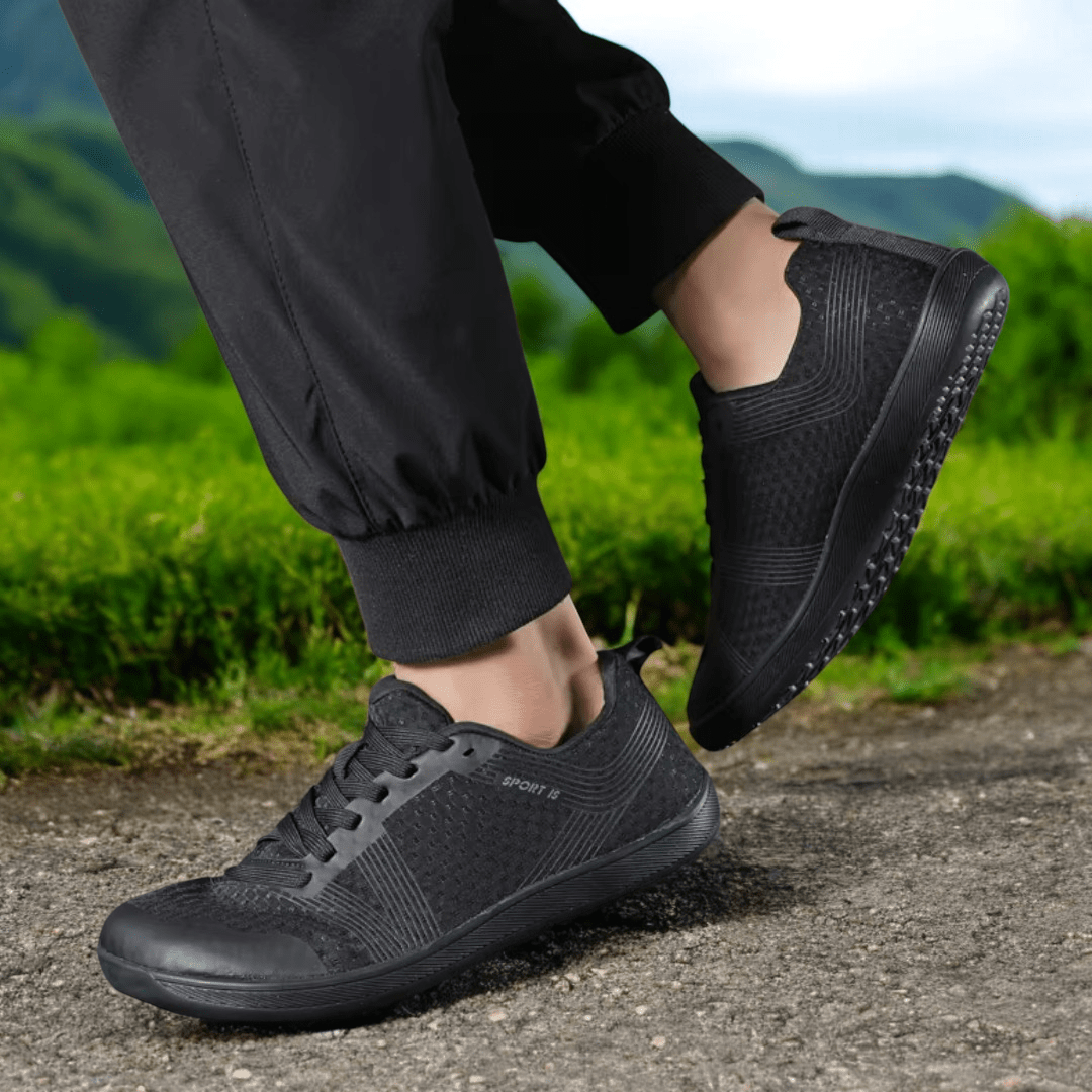 Person walking outdoors wearing black Naturcontact Metro Flex 2.0 everyday minimal barefoot shoes with flexible sole
