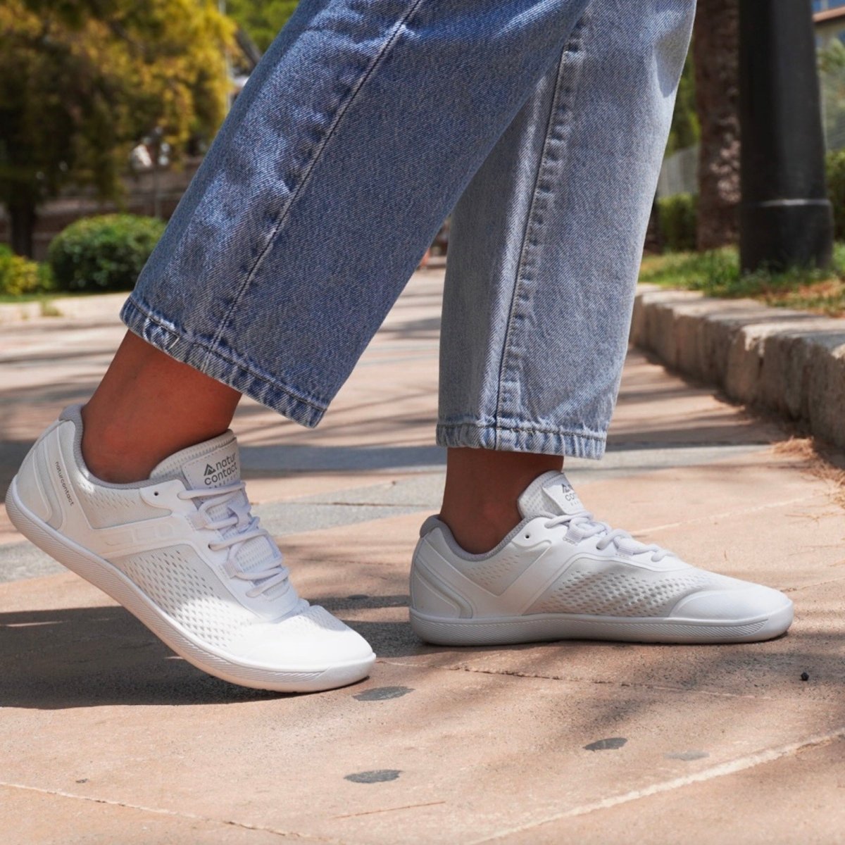 Person walking wearing Naturcontact Metro Flex 3.0 barefoot shoes on an urban surface