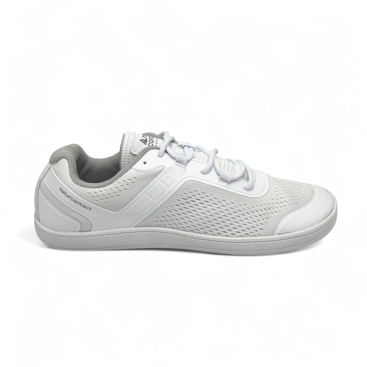 Side view of white Naturcontact Metro Flex 3.0 barefoot shoes with breathable mesh upper and flexible sole