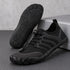 Black Sport Contact 2.0 barefoot shoes displayed as a pair, with one shoe showing its black rubber tread pattern.