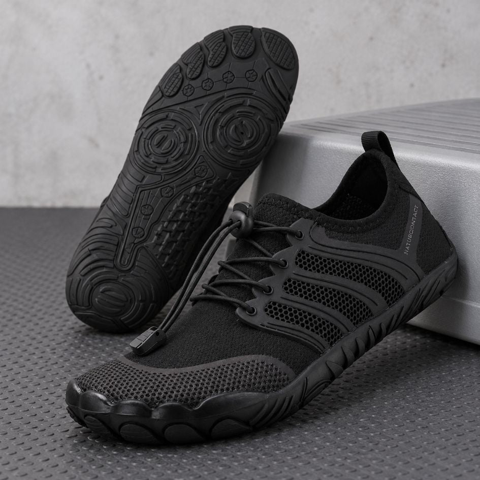 Black Sport Contact 2.0 barefoot shoes displayed as a pair, with one shoe showing its black rubber tread pattern.