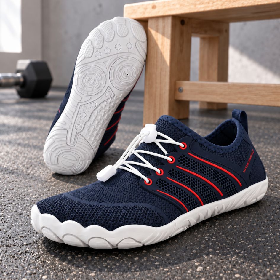 Navy blue and red Naturcontact Sport Contact 2.0 trainers displayed as a pair in a fitness setting, with one shoe showing its white outsole tread.