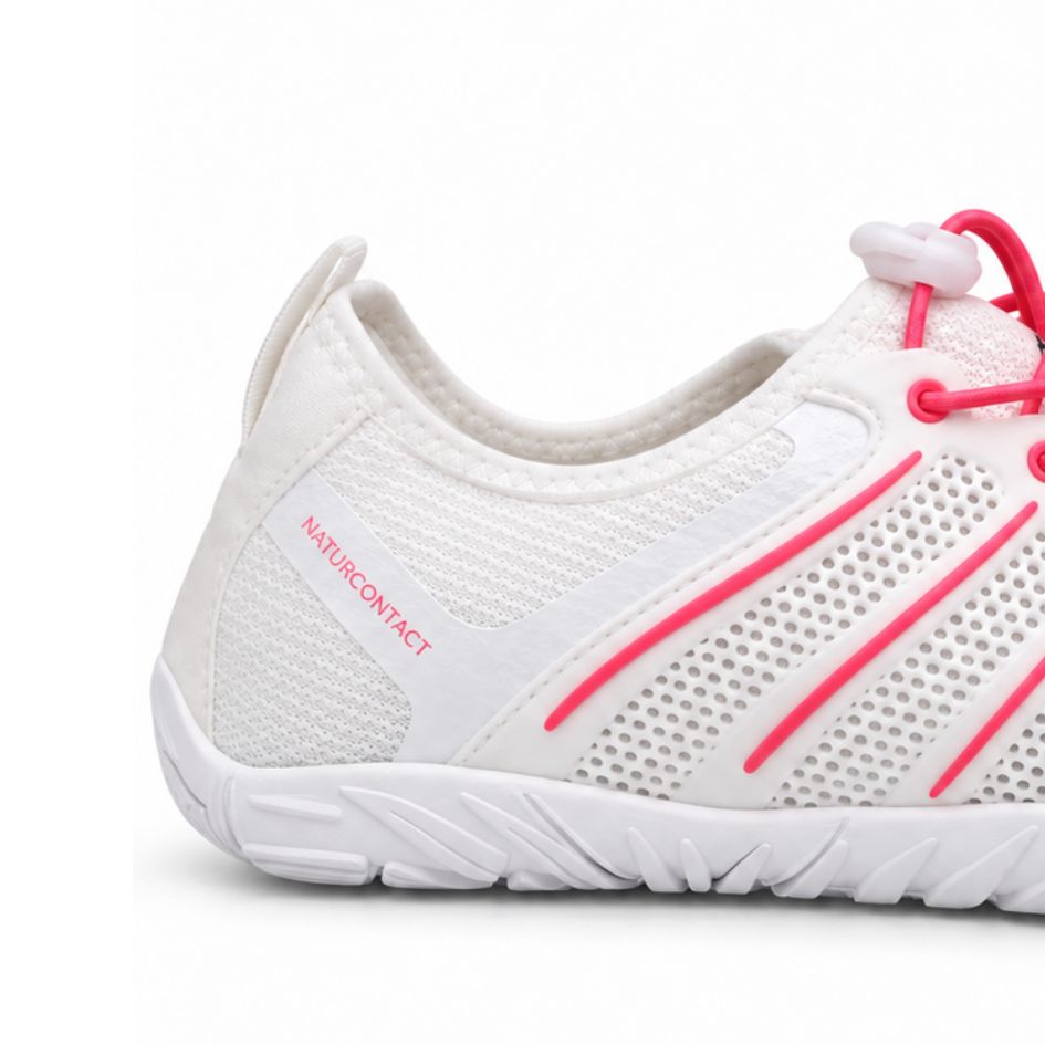 Heel close-up of white and pink Naturcontact Sport Contact 2.0 showing pink Naturcontact branding, mesh upper and white sole.