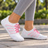 White and pink Sport Contact 2.0 barefoot trainers worn with grey leggings outdoors, showing both shoes in a natural walking pose.
