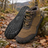 Pair of brown Storm Feel shoes beside a mossy rock on an autumn hiking trail.