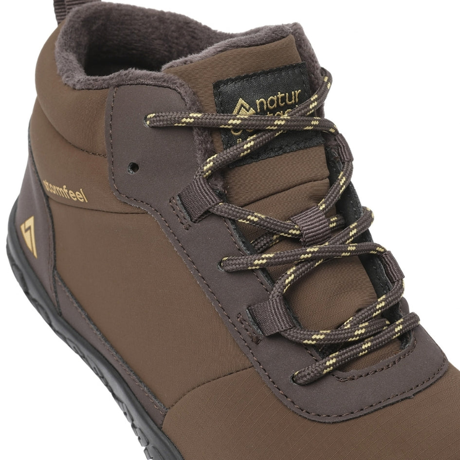 Close-up of the brown Storm Feel shoe showing its laces, tongue and fleece lining.