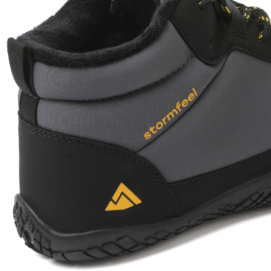 Close-up of the grey Storm Feel shoe showing the fleece collar, heel and branding.