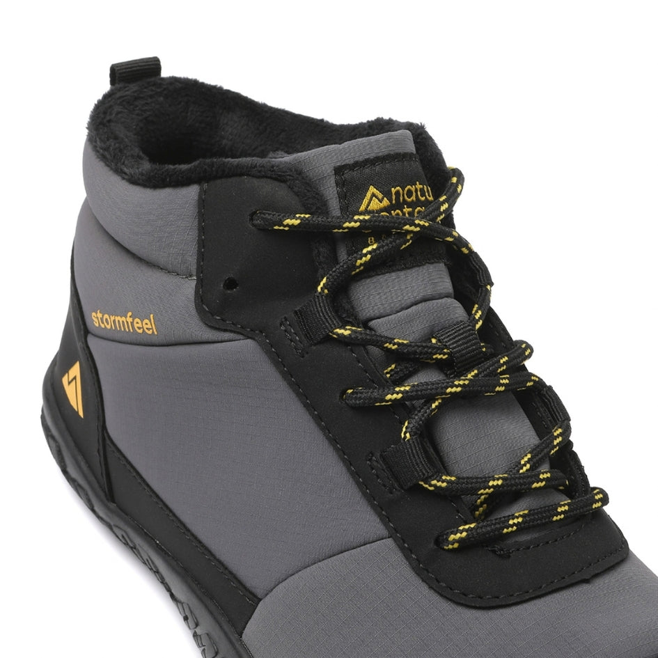 Close-up of the grey Storm Feel shoe showing its laces, tongue and fleece lining.