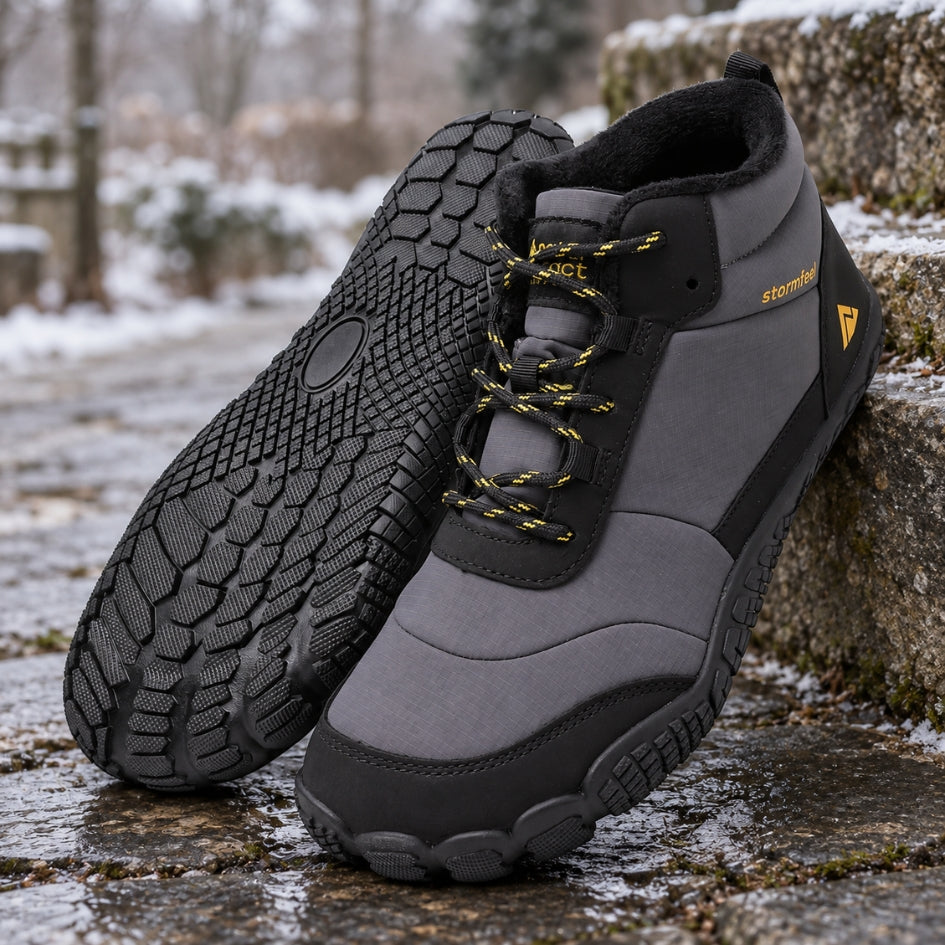 Pair of grey Storm Feel shoes on a wet winter path with patches of snow in the background.