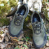 Pair of green and black shoes on a natural background with 'natur-Contact' branding.