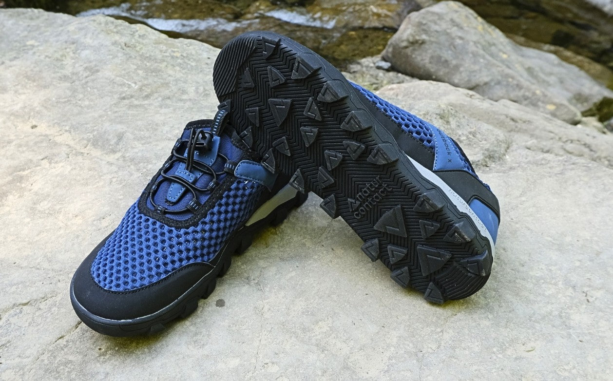 Blue and black hiking shoes on a rock surface