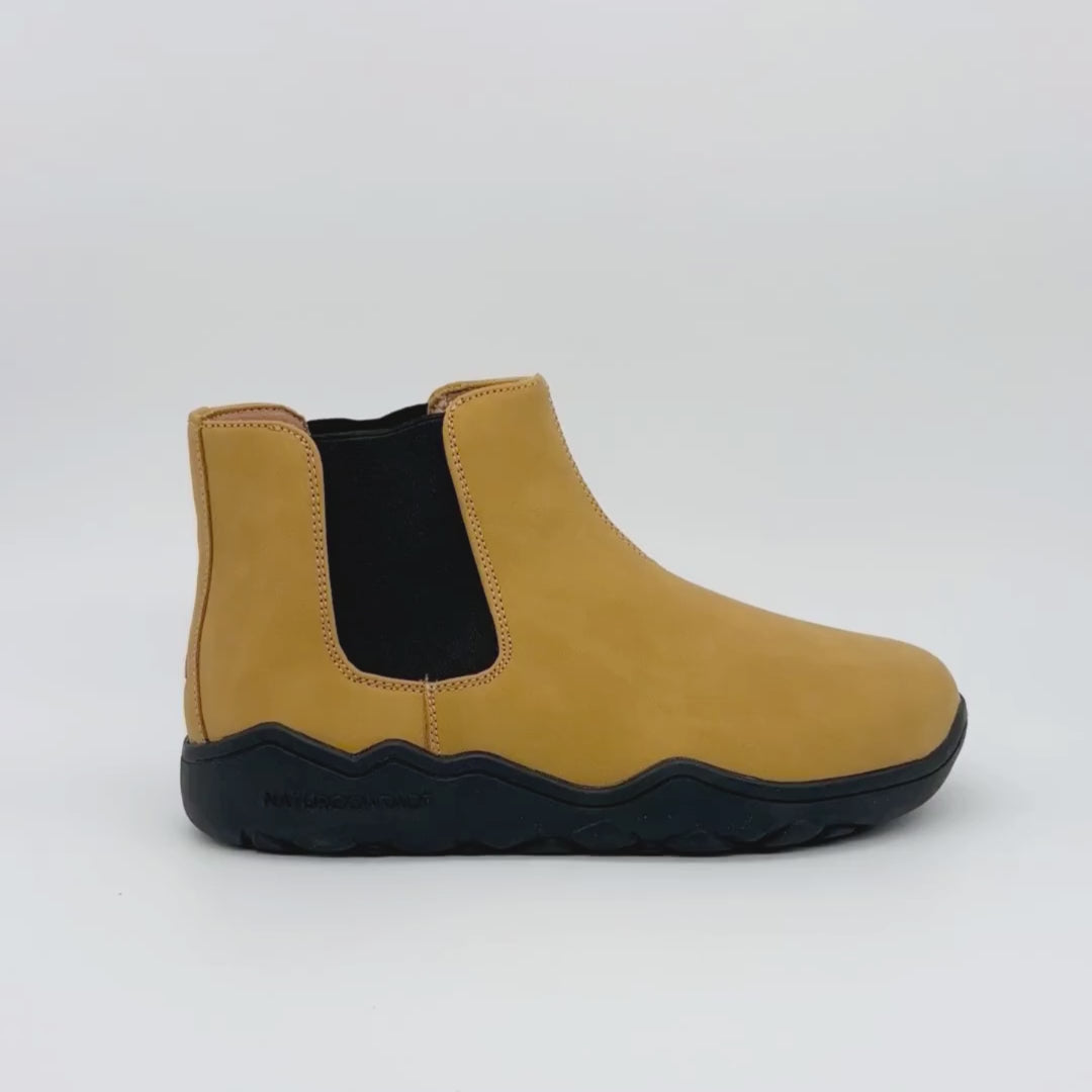 video of Yellow Chelsea boot with black sole on a white background