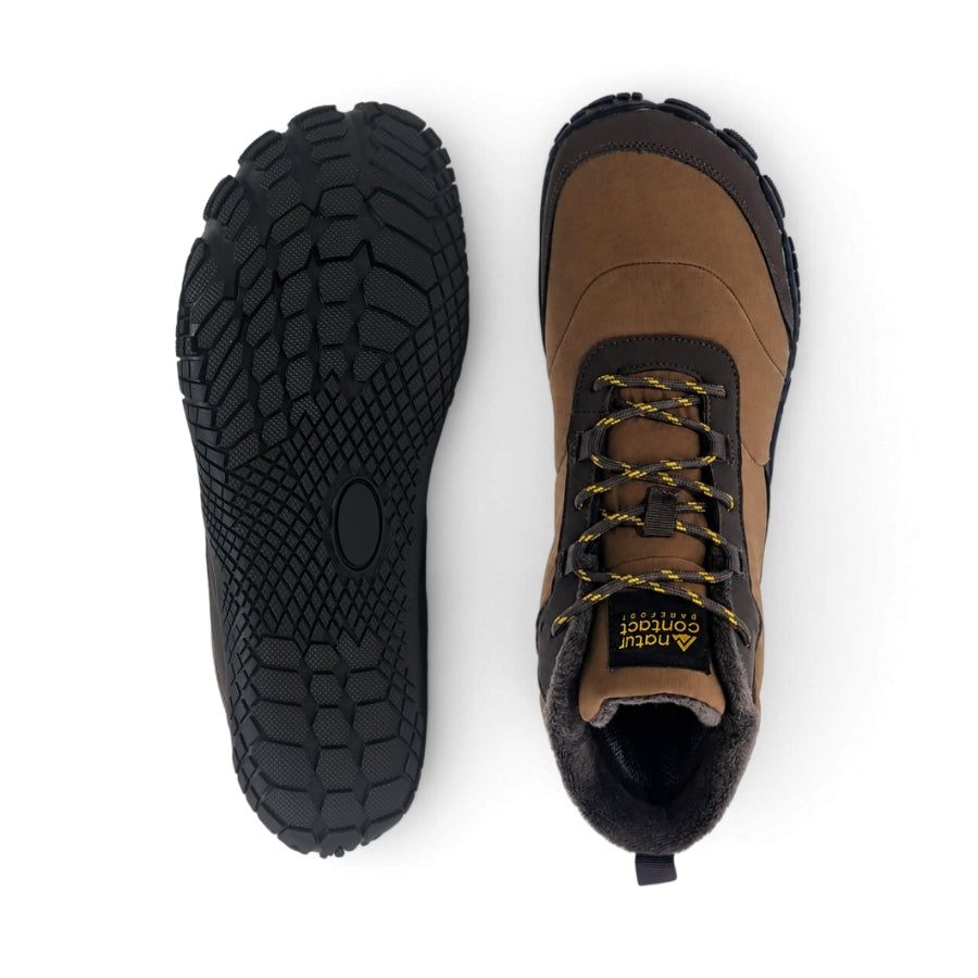 A pair of brown and black ankle boots shown from the top, with one boot displaying the textured black sole and the other showing the side profile with yellow laces and a visible 'Note' brand label.