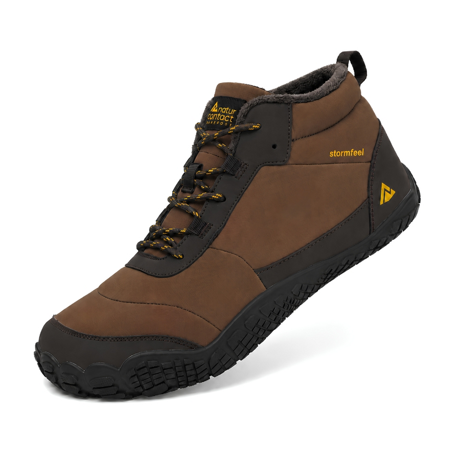 A brown and black mid-cut outdoor boot with yellow accents, featuring a rugged sole, black laces, and a pull tab, shown on a white background.