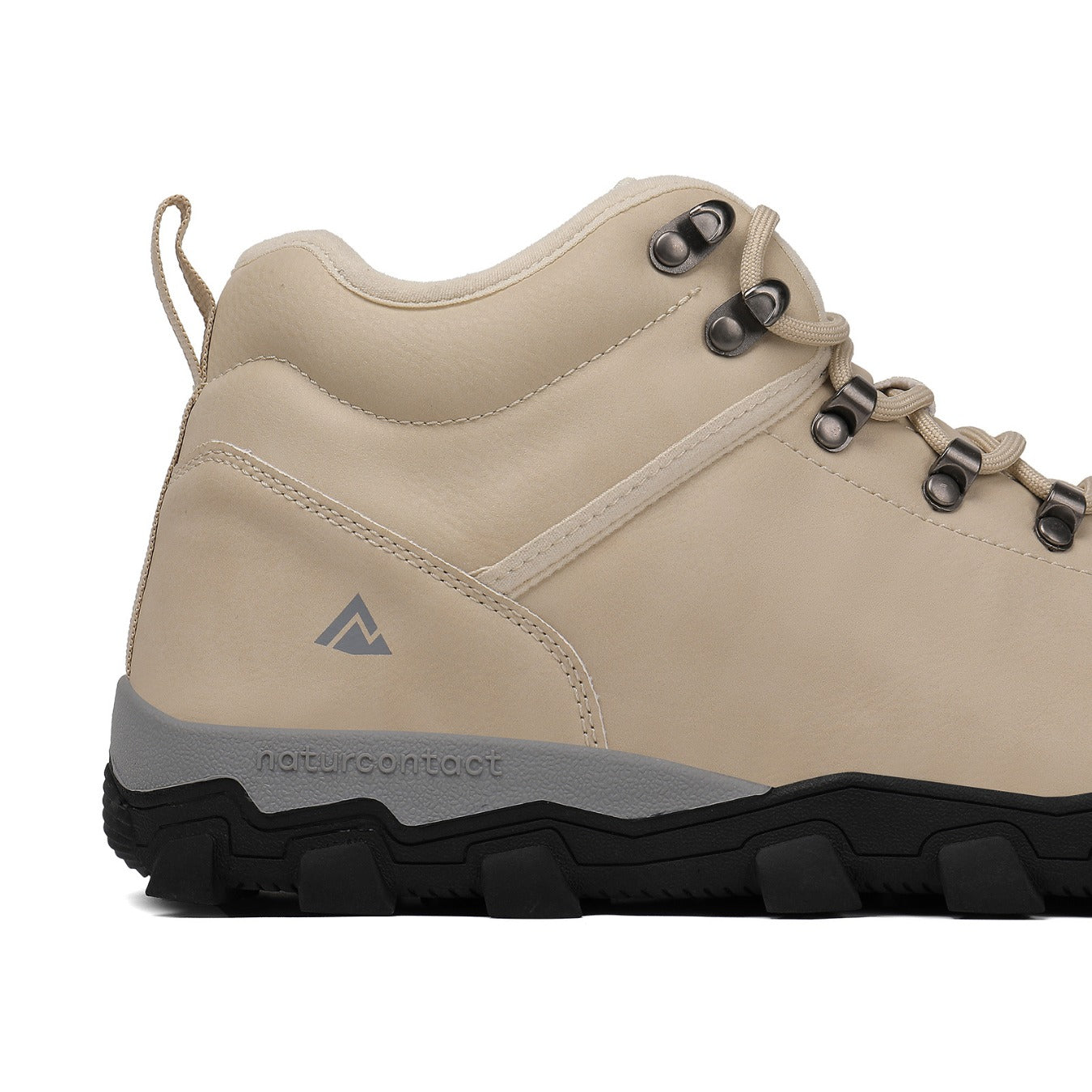 Beige hiking boot with black sole on a white background