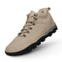 Beige hiking boot with black sole on a white background