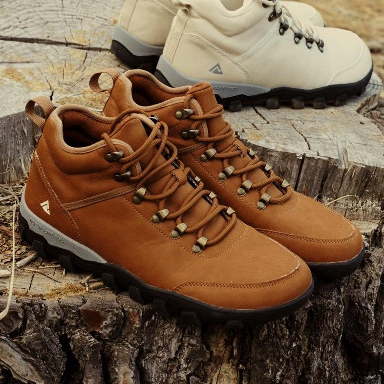 Brown hiking boots on a wooden surface