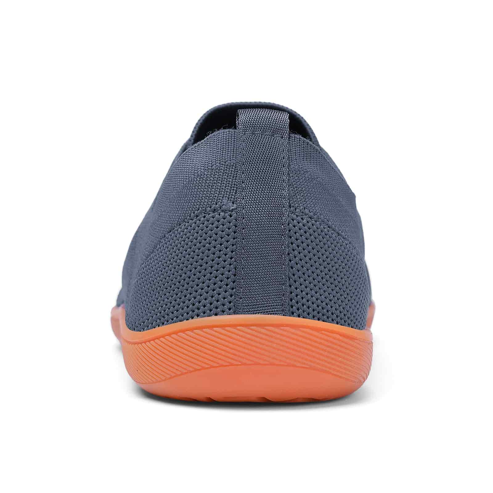 grey shoe with orange sole on a white background