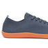 grey sneaker with orange sole on a white background