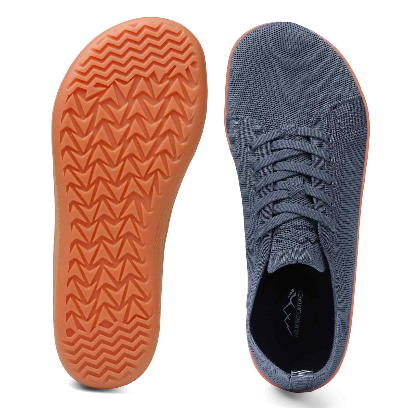 Grey sneaker with orange sole on a white background