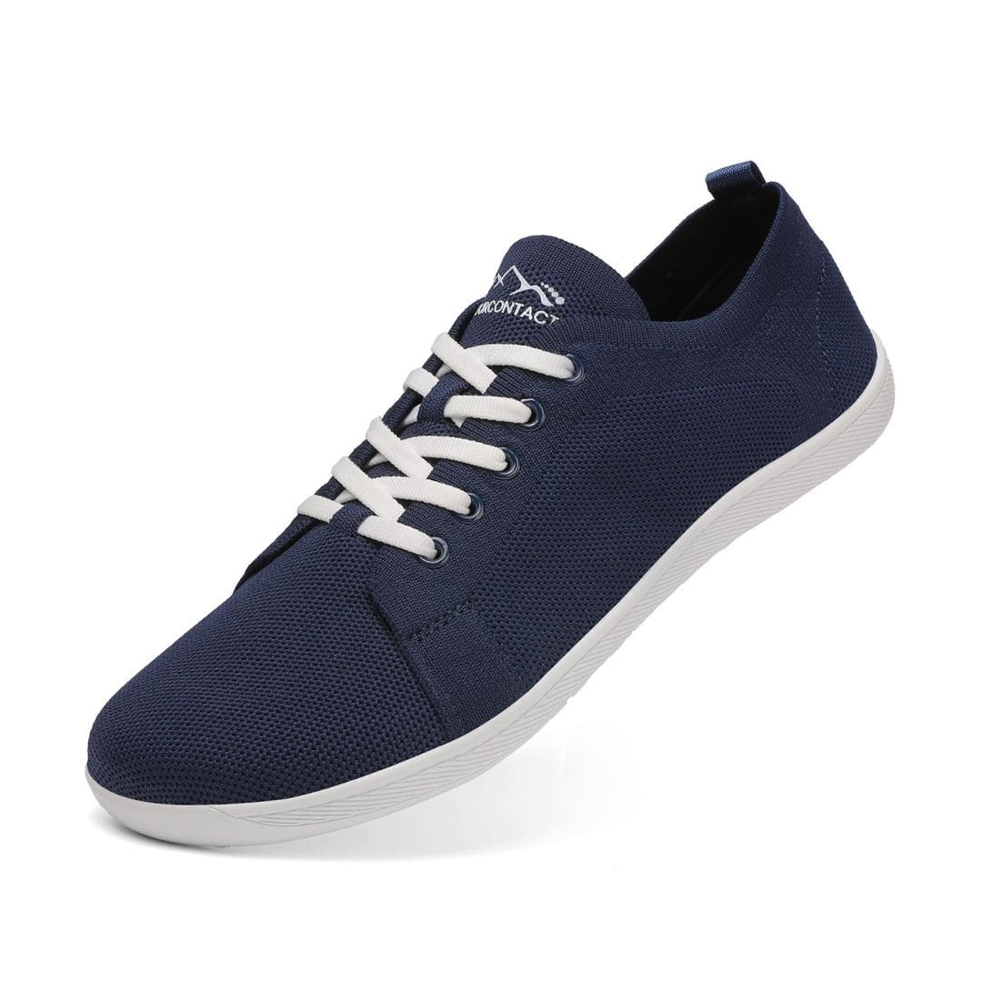 Navy blue sneaker with white laces on a white background